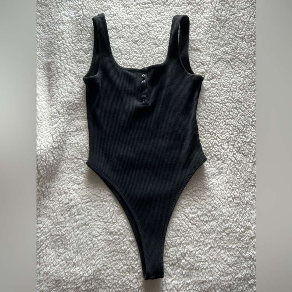 Black body suit, size large, with buttons at the top